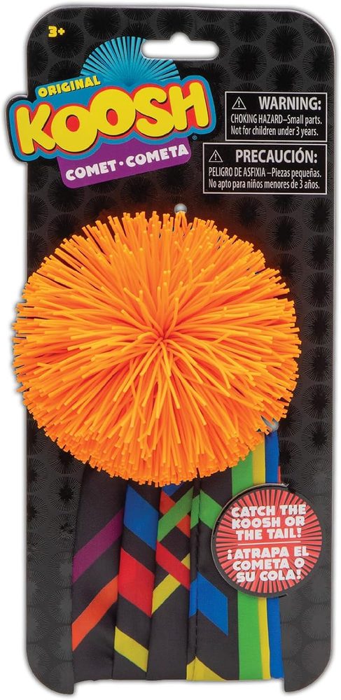 Koosh Comet ball with a long ribbon tail flying through the air